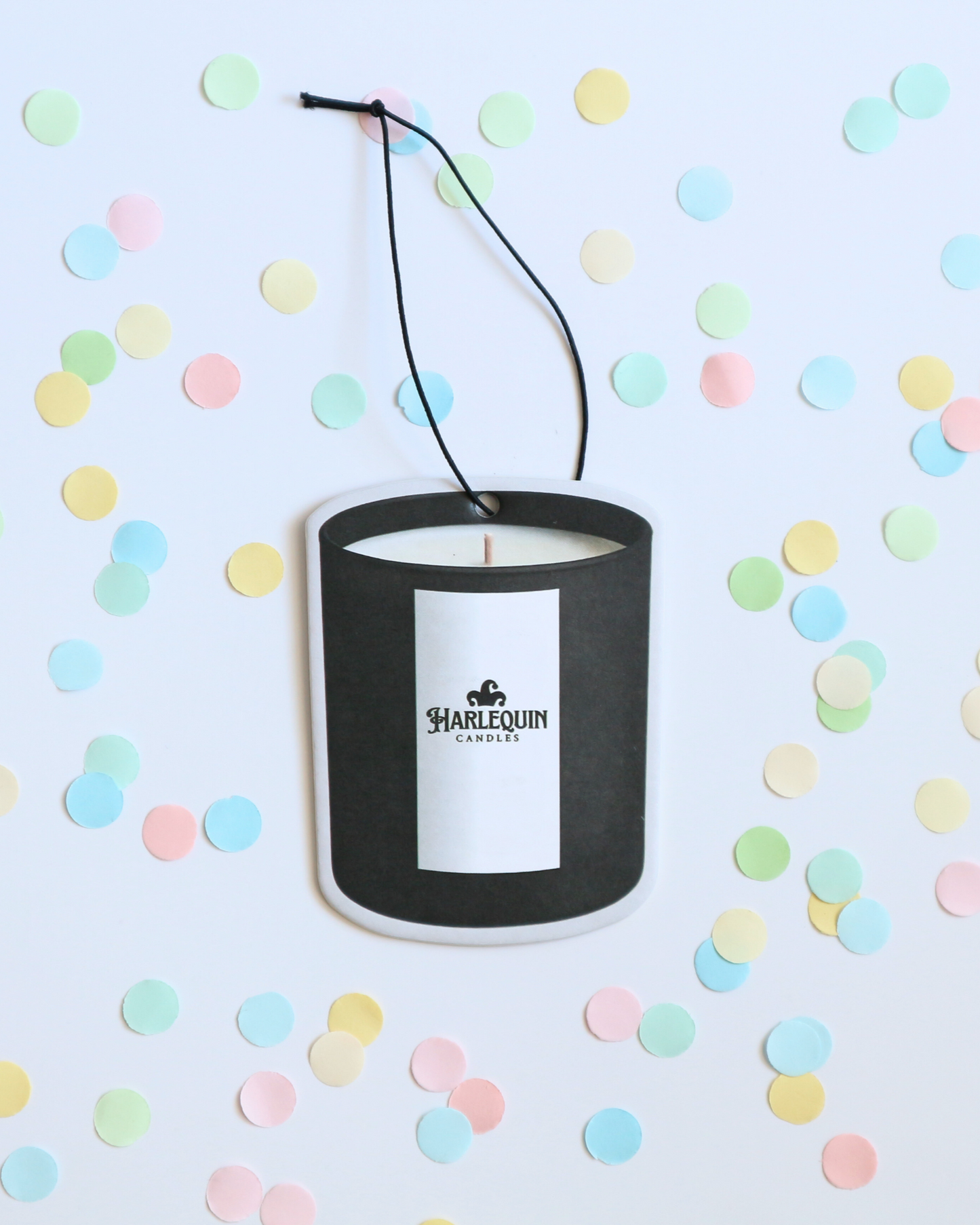 Black hanging car freshener with a Harlequin Candles logo. Candle design.