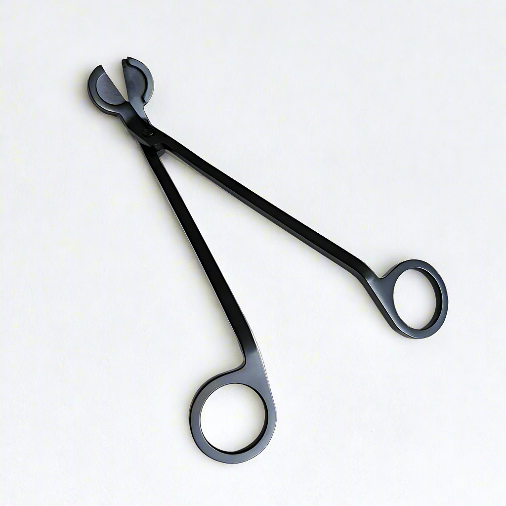 A sleek black candle wick trimmer with ergonomic handles, essential for maintaining your Harlequin Candles for a clean, even burn and extended candle life.