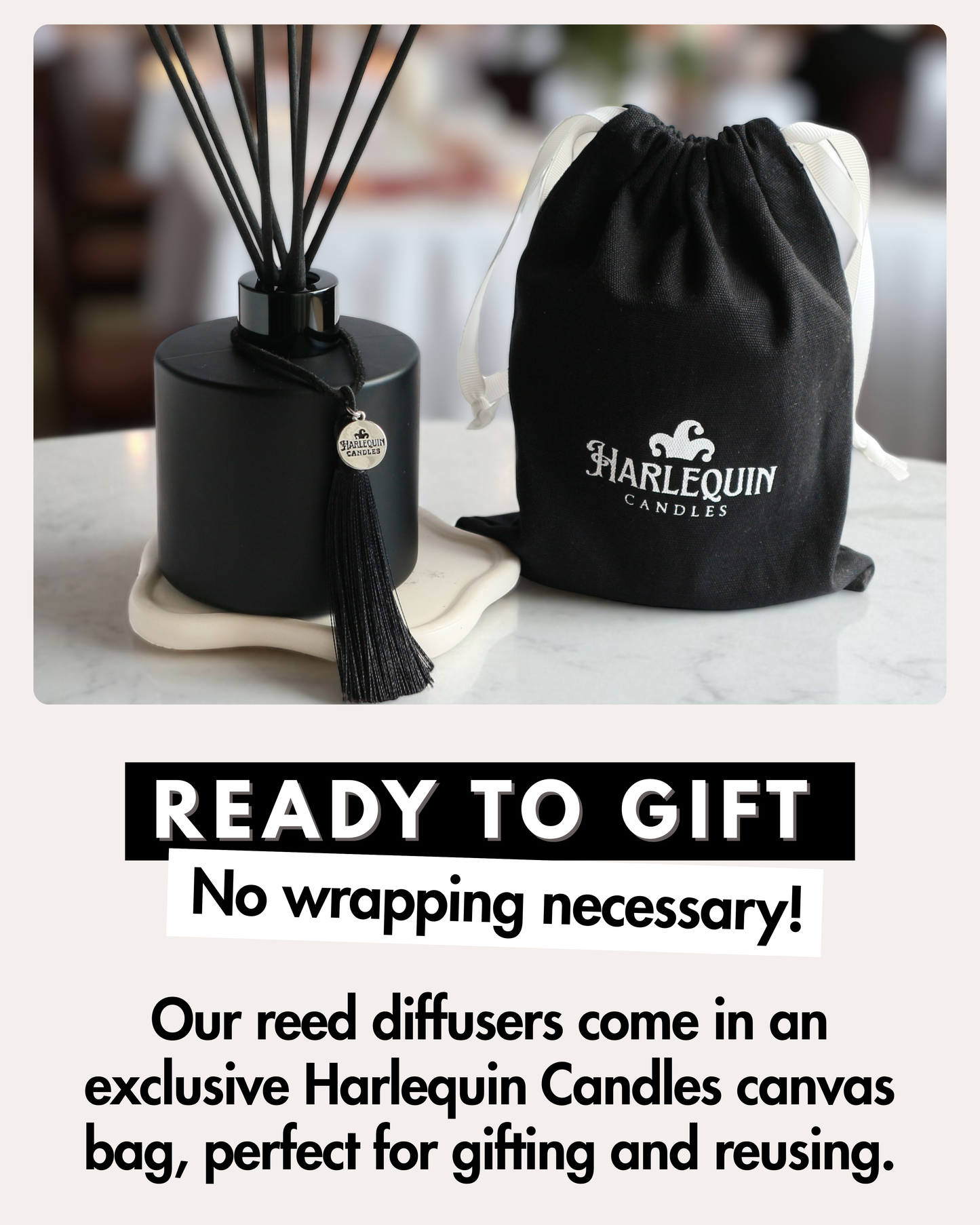 Harlequin Candles matte black reed diffuser with black reeds and tassel, displayed next to a black Harlequin Candles canvas drawstring gift bag with white ties. Large text reads 'READY TO GIFT No wrapping necessary!', highlighting the product's suitability for gifting and its reusable packaging.