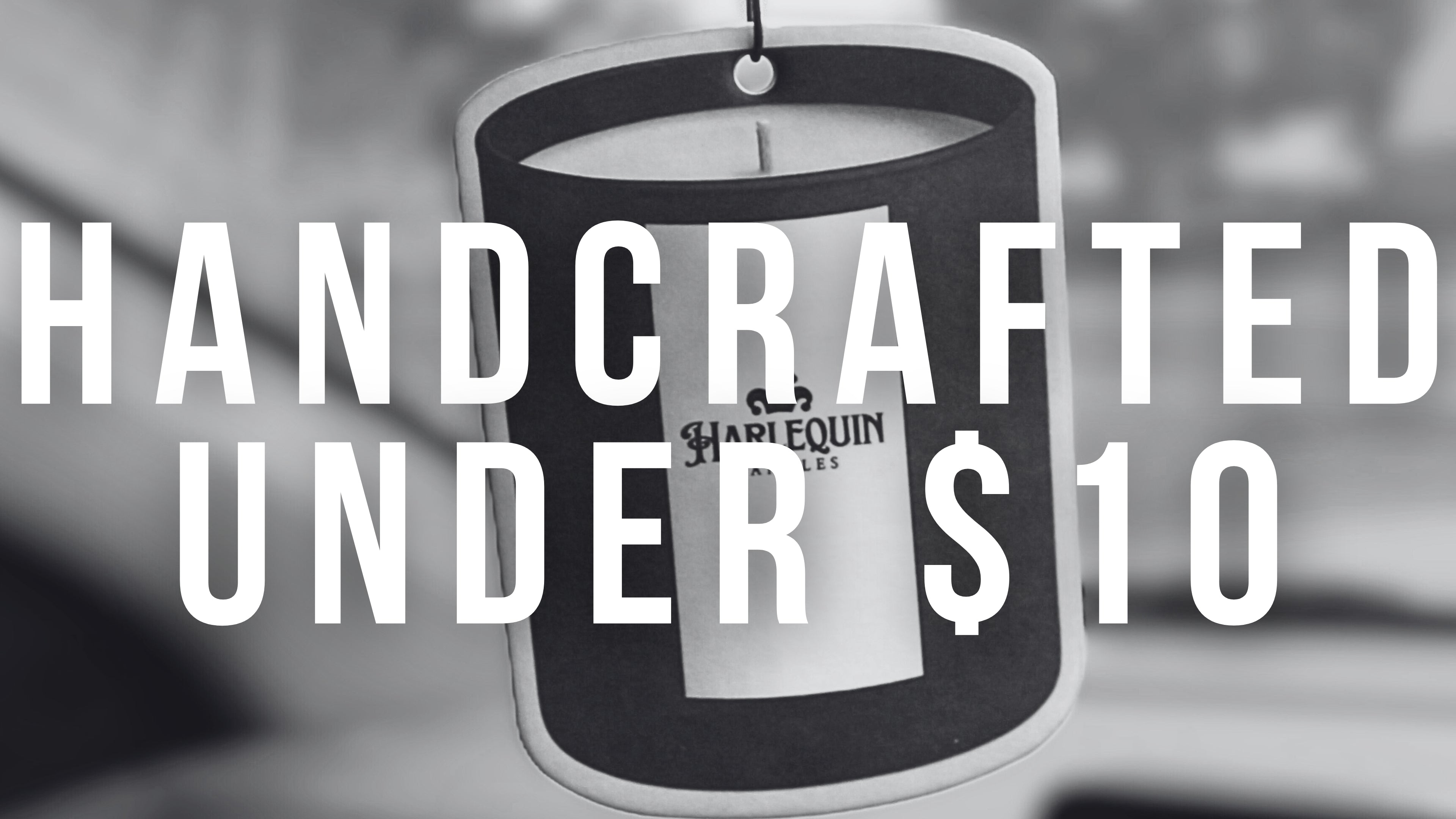 Monochrome banner with 'HANDCRAFTED UNDER $10' text overlaid on a candle shaped hanging car freshener, featuring the Harlequin Candles logo. Promotes affordable, handcrafted gifts and home fragrance items.