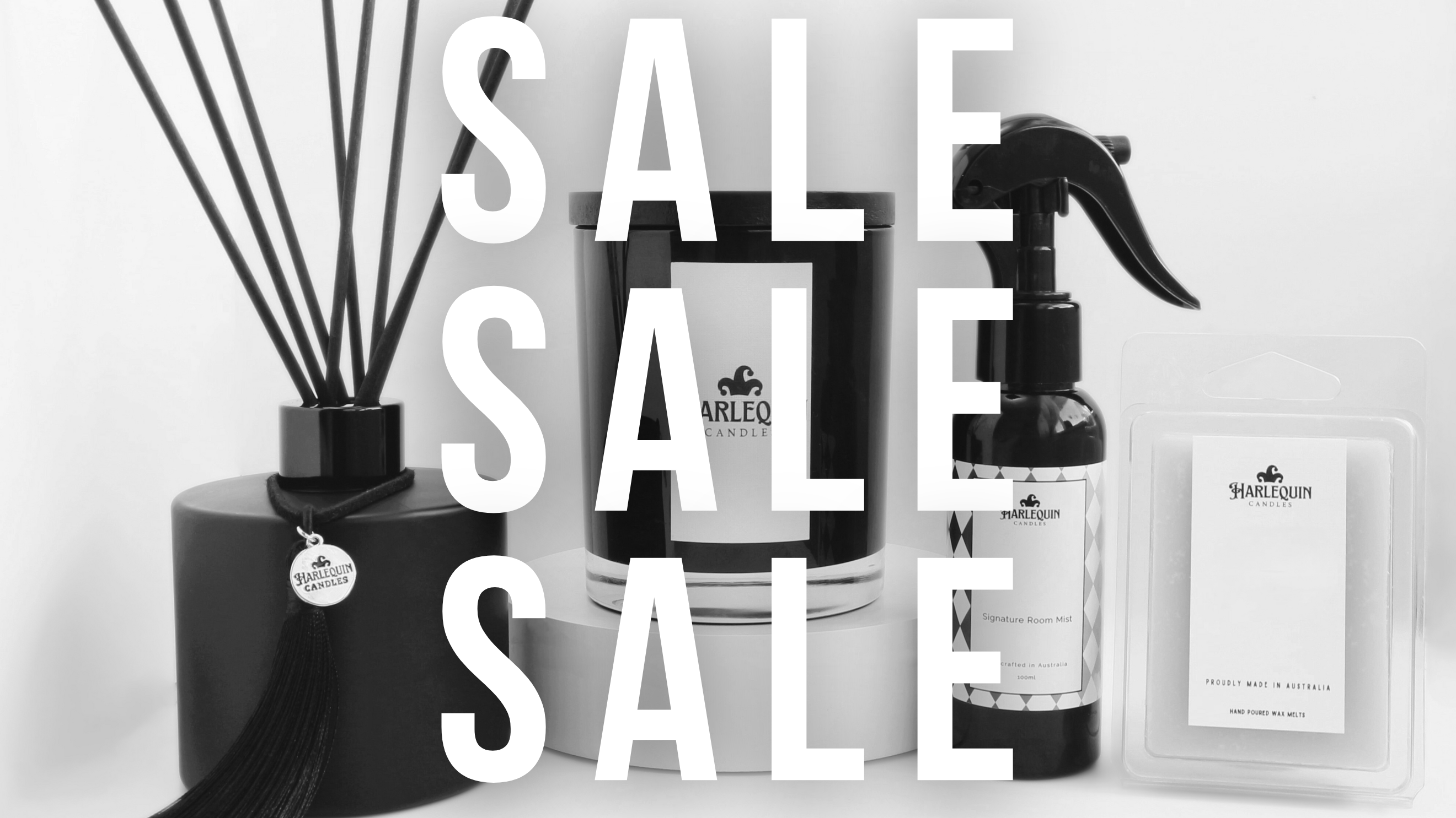 Monochrome banner featuring 'SALE' text prominently over a display of Harlequin Candles home fragrance products: a matte black reed diffuser, a black jar candle, a room mist spray, and soy wax melts. Promotes a special sale on premium home scents.