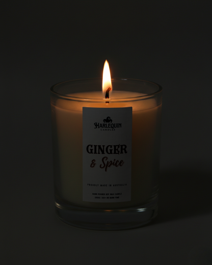 Hand-poured Australian Ginger & Spice soy candle flickering warmly in the dark. A perfect little everyday luxury, creating a cozy and inviting ambiance.