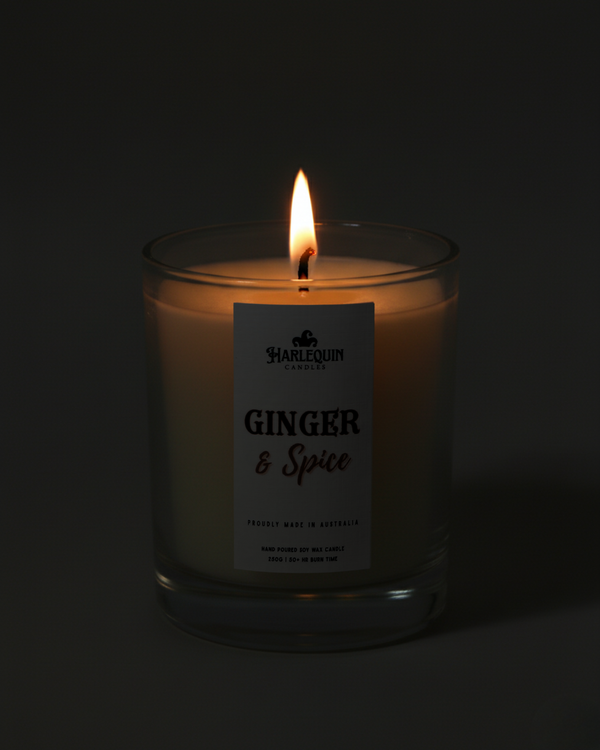 Hand-poured Australian Ginger & Spice soy candle flickering warmly in the dark. A perfect little everyday luxury, creating a cozy and inviting ambiance.