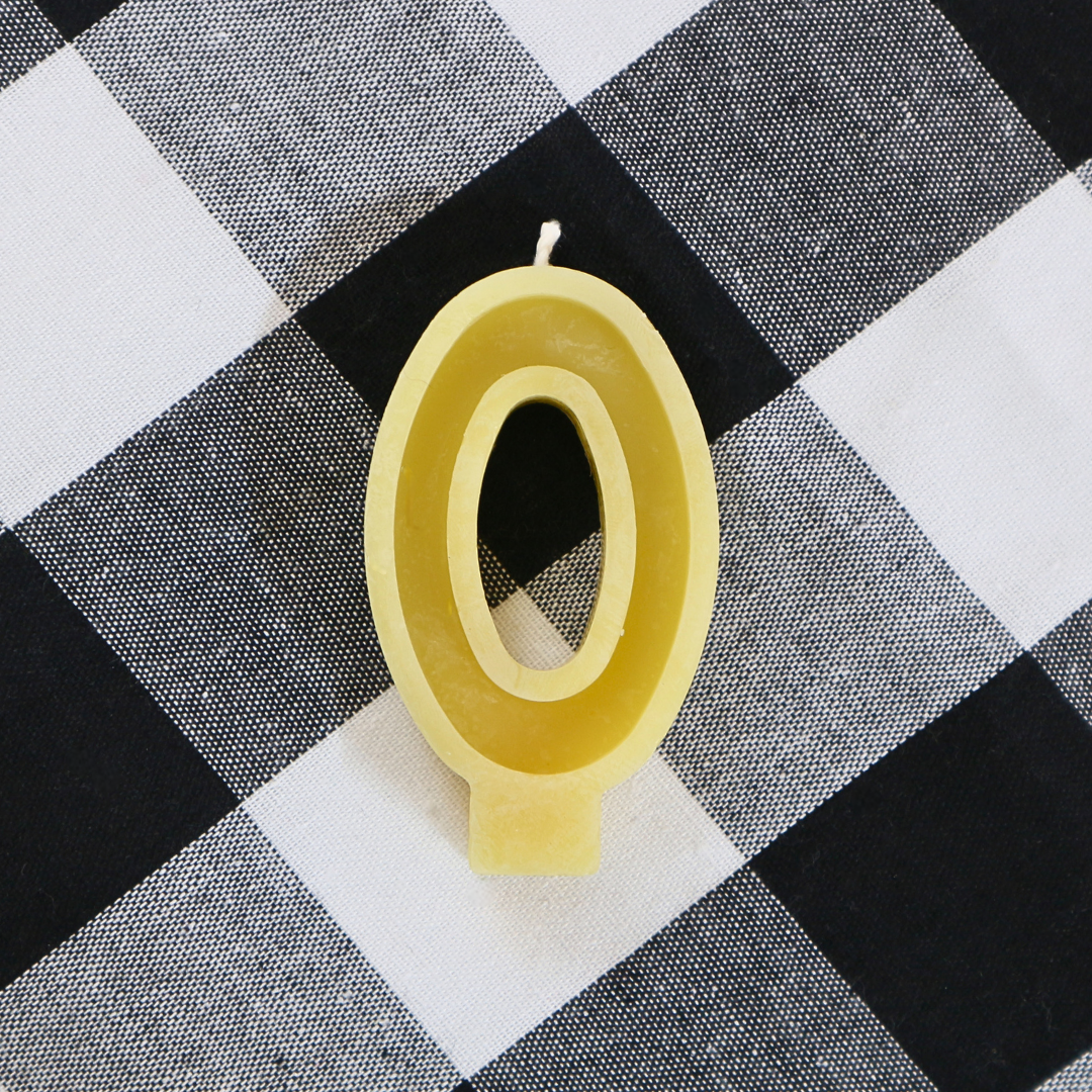 Handmade Australian beeswax number 0 birthday candle for milestone ages and birthday cakes.