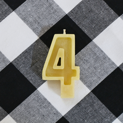 Handmade Australian beeswax number 4 birthday candle with a natural golden beeswax finish.