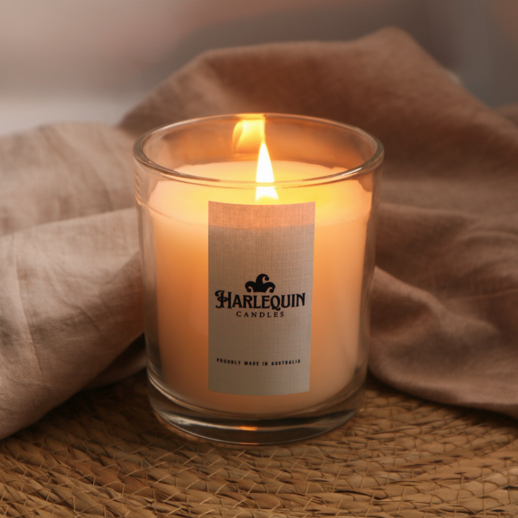 Harlequin Candles burning handmade soy candle in a clear glass jar, emphasized as a luxury scented candle Australia and an Australian made gift.