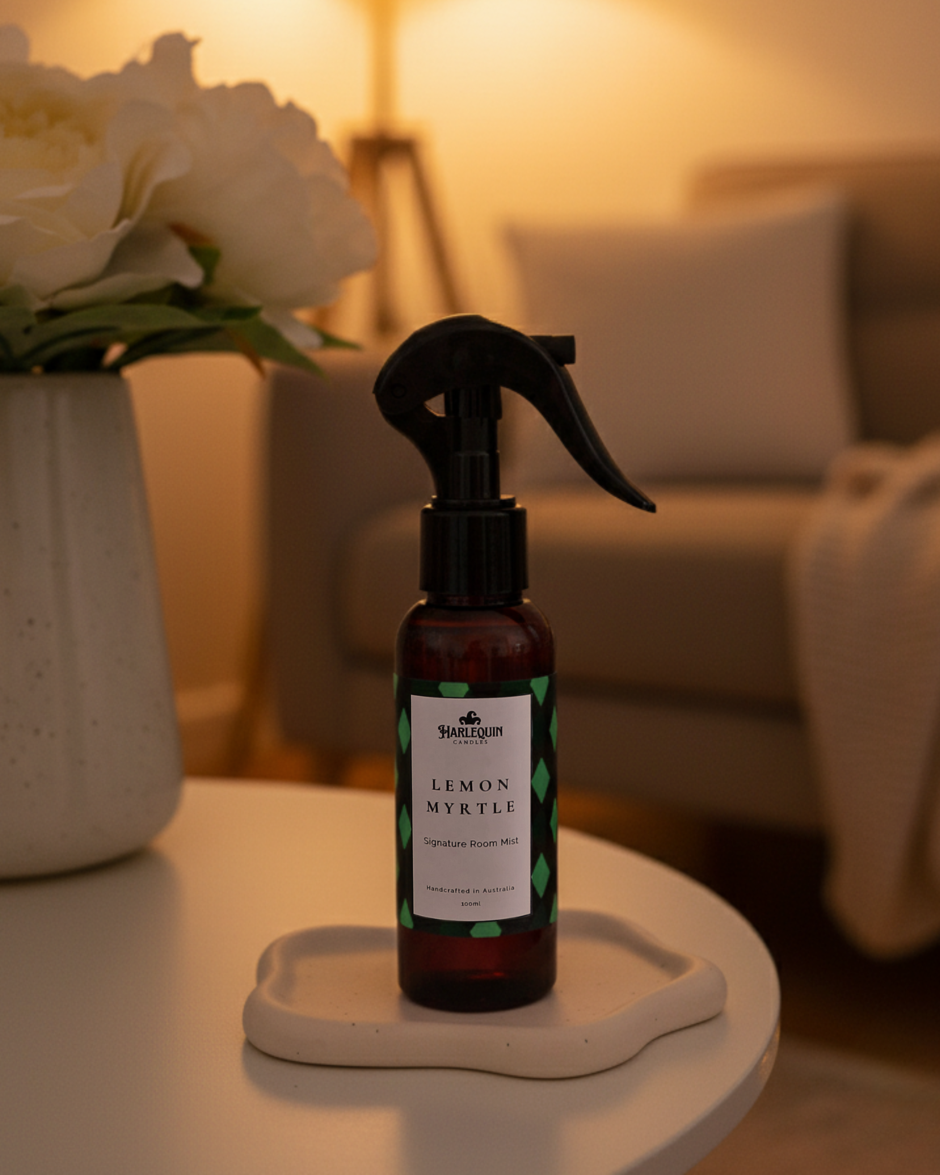 Harlequin Candles Lemon Myrtle Signature Room Mist in amber spray bottle. Refreshing lemon myrtle home fragrance, perfect for living rooms, bedrooms, or cozy spaces. Handcrafted, natural and relaxing scent.