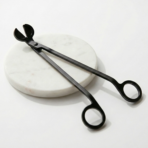 A sleek black candle wick trimmer with ergonomic handles, essential for maintaining your Harlequin Candles for a clean, even burn and extended candle life.