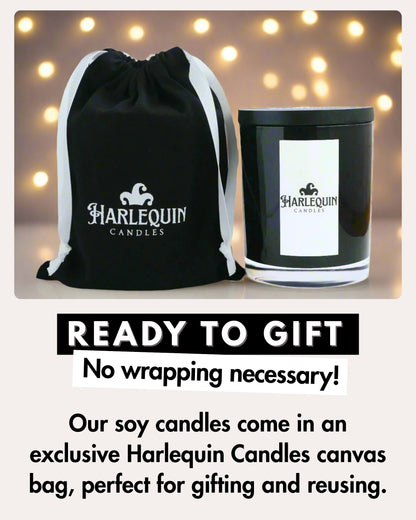 Harlequin Candles luxury scented soy candle in black glass jar with white label, presented in a black canvas drawstring gift bag. Perfect for gifting and reusable.