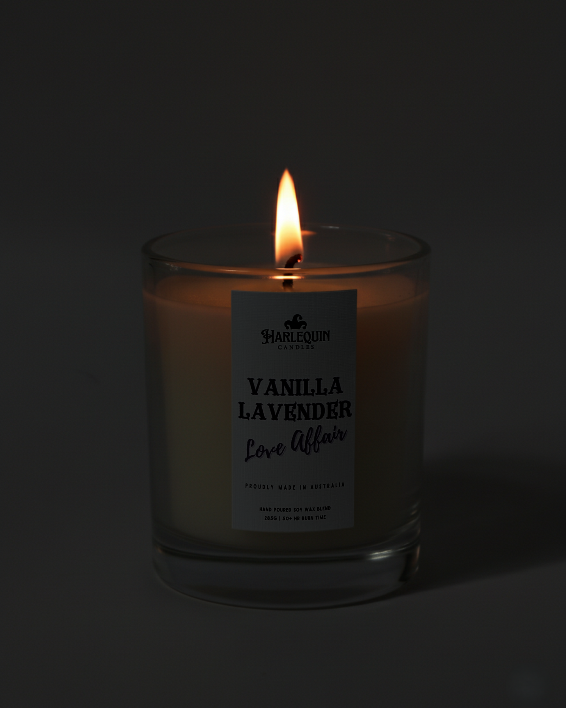 Hand-poured Australian Vanilla Lavender soy candle flickering warmly in the dark. A perfect little everyday luxury, creating a cozy and inviting ambiance.