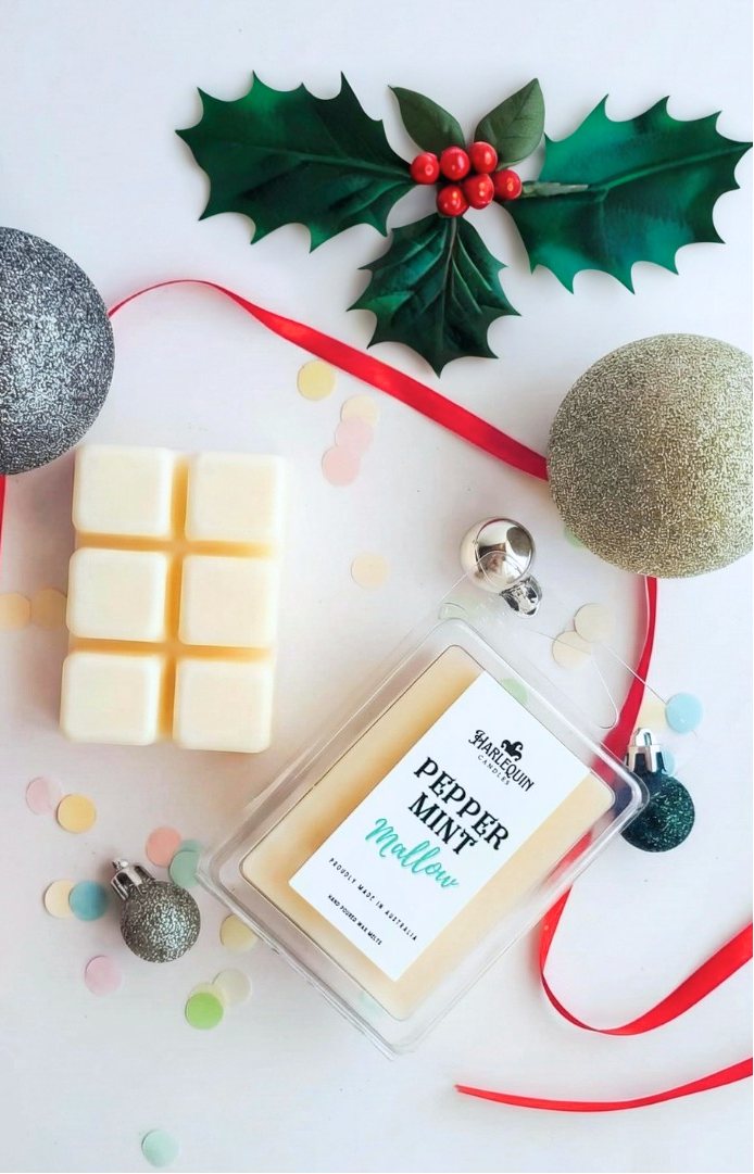 Harlequin Candles handmade soy wax melts in Gardenia Bloom and Peppermint Mallow scents, arranged with festive decorations. The perfect Australian-made Kris Kringle gift or  stocking stuffer or secret santa for home fragrance lovers.