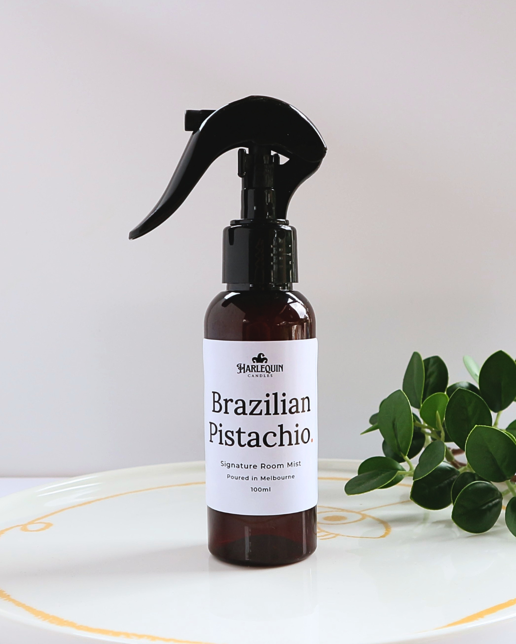 Harlequin Candles Bum Bum Type Brazilian Pistachio 100ml signature room mist in a premium amber spray bottle on a minimalist white ceramic tray, handmade in Melbourne Australia.