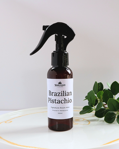 Harlequin Candles Bum Bum Type Brazilian Pistachio 100ml signature room mist in a premium amber spray bottle on a minimalist white ceramic tray, handmade in Melbourne Australia.
