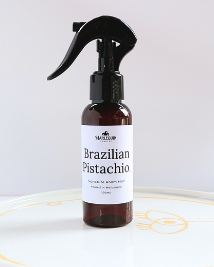 Harlequin Candles Brazilian Pistachio Bum Bum Type fragrance 100ml signature room mist in a premium amber spray bottle on a minimalist white ceramic tray, handmade in Melbourne Australia.