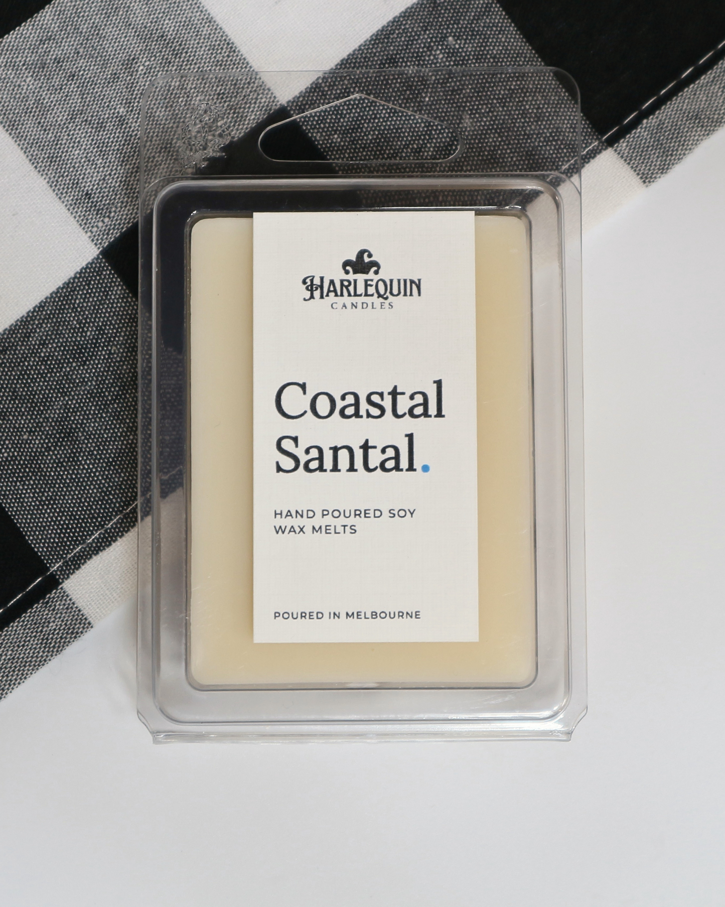 Coastal Santal soy wax melts by Harlequin Candles, hand-poured in Melbourne with fresh citrus, sandalwood and patchouli notes in a clear clamshell.