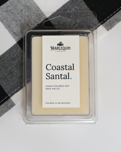 Coastal Santal soy wax melts by Harlequin Candles, hand-poured in Melbourne with fresh citrus, sandalwood and patchouli notes in a clear clamshell.
