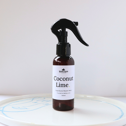 Harlequin Candles Coconut Lime 100ml signature room mist in a premium amber spray bottle on a clean white ceramic tray, handmade in Melbourne Australia.