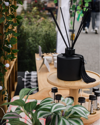 Flower Shop reed diffuser by Harlequin Candles displayed at Bentleigh Sunday Market in Melbourne with black reeds and fragrance testers.