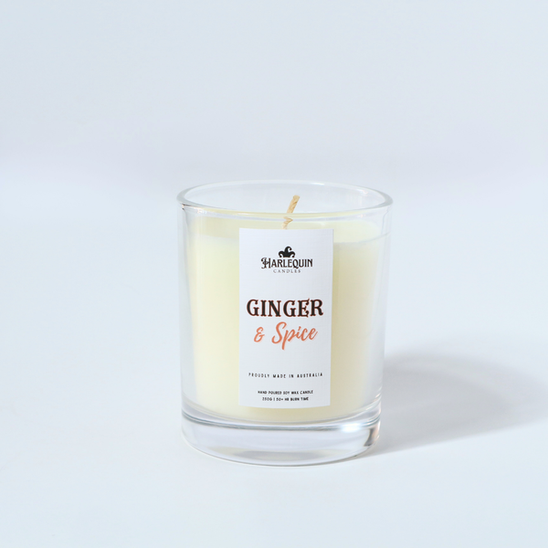 A Harlequin Candles "Ginger ans Spice" hand-poured soy wax candle in a clear glass jar.  Premium Australian made scented candle.