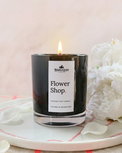 Hand-poured Harlequin Coconut Soy Candle in Flower Shop scent on a white stylised plate; handmade Melbourne gift ideas for Mother's Day.