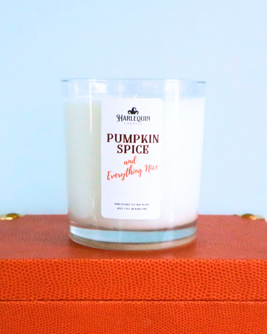 A Harlequin Candles "Pumpkin Spice and Everything Nice" hand-poured soy wax candle in a clear glass jar, displayed on a decorative orange box. Premium Australian made scented candle.