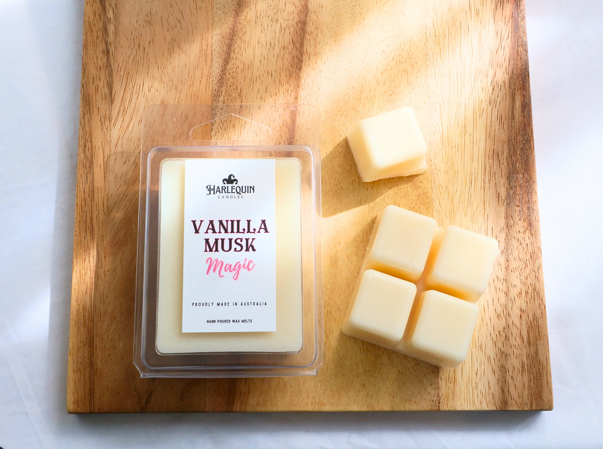 Vanilla Musk Magic Soy Wax Melts in a Clamshell, next to some Soy Wax Cubes 