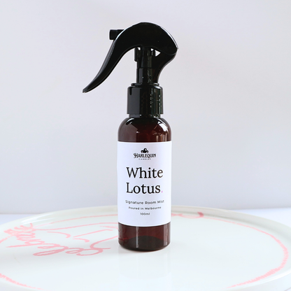 Harlequin Candles White Lotus 100ml signature room mist in an amber spray bottle on a white designer ceramic tray, hand-poured in Melbourne.