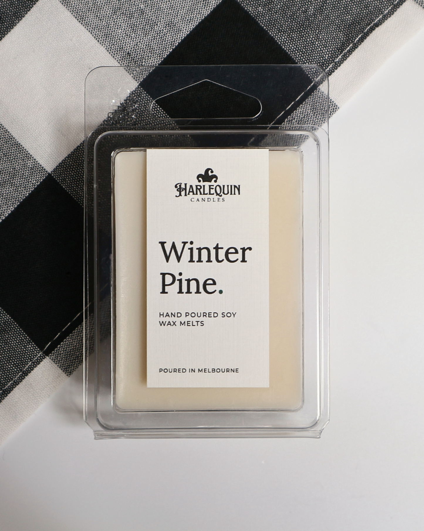 Winter Pine soy wax melts by Harlequin Candles, hand-poured in Melbourne with bergamot, pine, cedarwood and patchouli in a clear clamshell.